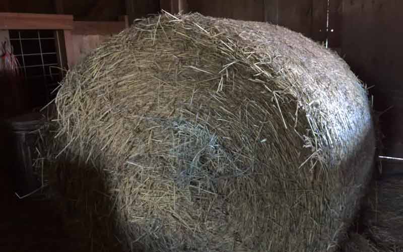 Bale of hay in a dark barn