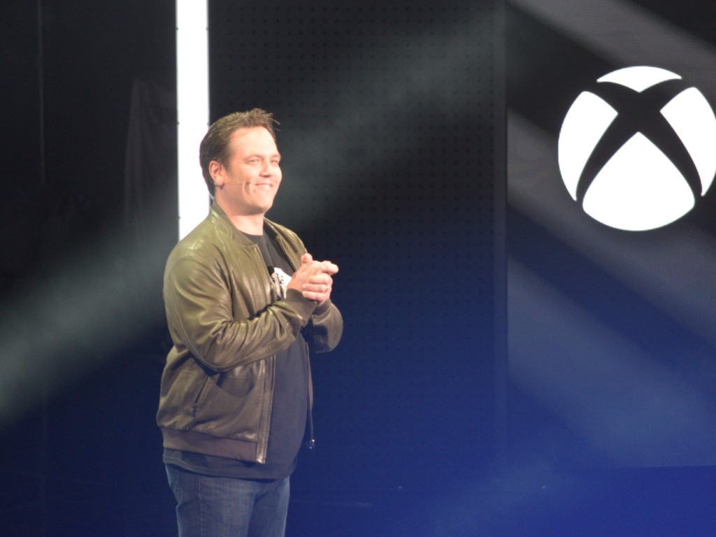 Xbox head Phil Spencer onstage with Xbox logo