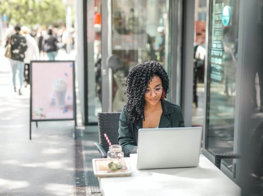 Woman using Grammarly extension on laptop outside